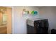 Well-lit laundry room with washer, dryer, and storage shelving at 309 Bowfin Trl, Mcdonough, GA 30253