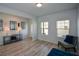 Bright living room with hardwood floors and comfy seating at 309 Bowfin Trl, Mcdonough, GA 30253