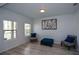 Sitting room with light walls, wood-look floors, and comfy seating at 309 Bowfin Trl, Mcdonough, GA 30253