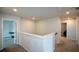 Upstairs hallway with carpet and multiple doors at 309 Bowfin Trl, Mcdonough, GA 30253