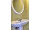 Bathroom featuring a white sink with silver faucet and oval mirror with a white frame at 2878 Norfair Loop, Lithonia, GA 30038