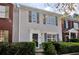 Charming townhome featuring neutral siding, complemented by dark shutters and mature landscaping at 2878 Norfair Loop, Lithonia, GA 30038