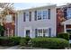 Charming townhome featuring neutral siding, complemented by dark shutters and mature landscaping at 2878 Norfair Loop, Lithonia, GA 30038