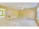 View of the living room area with a ceiling fan and natural lighting from the windows at 2878 Norfair Loop, Lithonia, GA 30038