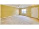 View of the living room area, with an entrance door, a window for natural lighting, and a ceiling fan at 2878 Norfair Loop, Lithonia, GA 30038