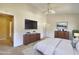 This staged main bedroom has wooden dressers and a wall-mounted TV at 2878 Norfair Loop, Lithonia, GA 30038