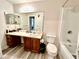 Functional bathroom with extended vanity, bathtub, and tiled shower at 4079 Woodridge Way, Tucker, GA 30084