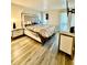 Bright bedroom featuring a large bed, modern nightstands, and sleek floors at 4079 Woodridge Way, Tucker, GA 30084