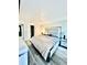View of the bedroom featuring a large bed, hardwood floors, and natural light at 4079 Woodridge Way, Tucker, GA 30084