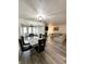 View of the dining room and living room, with wood floors and ample seating at 4079 Woodridge Way, Tucker, GA 30084