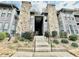 View of the condo's exterior featuring stone accents and landscaping at 4079 Woodridge Way, Tucker, GA 30084
