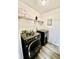 Compact laundry room with modern washer and dryer, plus wire shelving at 4079 Woodridge Way, Tucker, GA 30084