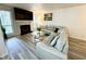 View of the living room featuring a fireplace, large sofa, and gray wood floors at 4079 Woodridge Way, Tucker, GA 30084