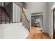 View of the foyer's staircase with hardwood floors and an office space beyond an open doorway at 2025 Cresthaven Walk, Woodstock, GA 30189