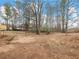 Large backyard with mature trees and playset at 2600 Sims Crest Ct, Snellville, GA 30078