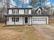 Two-story house with white siding, black accents, and a two-car garage at 2600 Sims Crest Ct, Snellville, GA 30078