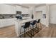 This spacious kitchen features an island with seating, white cabinets, and modern appliances at 2712 Sw Riverpine Lot 175 Sw Trl, Atlanta, GA 30331