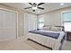 Bright main bedroom featuring three closets, a ceiling fan, and carpet flooring at 2848 Monticello Pl, Decatur, GA 30030