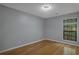 Bedroom with hardwood floors and a window offering natural light at 643 Windchase Ln, Stone Mountain, GA 30083