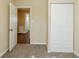 A bedroom featuring neutral walls, carpet flooring, and a closet with bi-fold doors at 2720 Santa Barbara Nw Dr, Atlanta, GA 30318