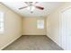 Bright bedroom featuring neutral walls, carpet flooring, a ceiling fan and a window at 2720 Santa Barbara Nw Dr, Atlanta, GA 30318