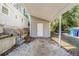 Carport area leading to a doorway, with steps to the side and trash cans nearby at 2720 Santa Barbara Nw Dr, Atlanta, GA 30318