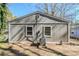 Side exterior view with gray siding and a small yard, showcasing the home's simple and functional design at 2720 Santa Barbara Nw Dr, Atlanta, GA 30318
