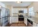 This kitchen is equipped with stainless steel appliances and granite countertops at 2720 Santa Barbara Nw Dr, Atlanta, GA 30318