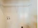 A practical laundry area with shelving for storage and hookups for appliances at 2720 Santa Barbara Nw Dr, Atlanta, GA 30318
