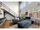 Open living area with sectional sofa, hardwood floors, and modern staircase at 260 18Th St # 10320, Atlanta, GA 30363