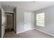 Bedroom with neutral walls and carpet, showcasing a window and closet space at 804 Thomasville Se Blvd, Atlanta, GA 30315
