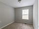 Bedroom featuring plush carpeting, neutral walls, and a large window at 804 Thomasville Se Blvd, Atlanta, GA 30315
