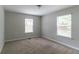 Bright bedroom with two windows, neutral walls and carpet, offering ample natural light at 804 Thomasville Se Blvd, Atlanta, GA 30315