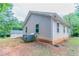 Side view of the home featuring light siding, white trim windows, and a well-maintained lawn at 804 Thomasville Se Blvd, Atlanta, GA 30315