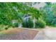 Home exterior showing manicured yard and driveway, surrounded by lush trees at 804 Thomasville Se Blvd, Atlanta, GA 30315