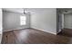 Bright living room featuring wood floors, a ceiling fan, and a large window at 804 Thomasville Se Blvd, Atlanta, GA 30315