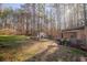 Backyard with mature trees, lawn, storage shed, and chicken coop at 1620 Palm St, Canton, GA 30115
