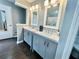Updated bathroom with double vanity sinks, modern fixtures and wood flooring at 1620 Palm St, Canton, GA 30115