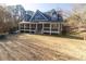 Inviting two-story home featuring a charming front porch and well-maintained lawn at 1620 Palm St, Canton, GA 30115
