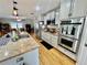 Modern kitchen featuring stainless steel appliances, granite countertops, and hardwood floors at 1620 Palm St, Canton, GA 30115