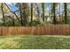 Large backyard with wooden fence and lush green grass at 1318 Graymont Sw Dr, Atlanta, GA 30310