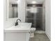 Modern bathroom with a large glass shower and white vanity at 1318 Graymont Sw Dr, Atlanta, GA 30310