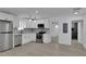 Modern white kitchen with stainless steel appliances and gray flooring at 1318 Graymont Sw Dr, Atlanta, GA 30310