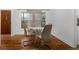 Bright dining room with hardwood floors and a glass-top table at 1386 Sandy Ln, Decatur, GA 30032