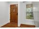 Inviting entryway with wood door and hardwood floors at 1386 Sandy Ln, Decatur, GA 30032