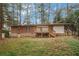 Brick ranch house with a deck in the backyard at 1386 Sandy Ln, Decatur, GA 30032