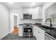 Modern kitchen with white cabinets, stainless steel appliances, and dark countertops at 1386 Sandy Ln, Decatur, GA 30032