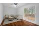 Living room with hardwood floors, a ceiling fan, and access to a deck at 1386 Sandy Ln, Decatur, GA 30032