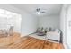 Living room with hardwood floors, a ceiling fan, and access to a deck at 1386 Sandy Ln, Decatur, GA 30032