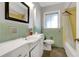 Retro style bathroom with green and yellow tile, tub and shower combo at 1405 Pinehurst Sw Dr, Atlanta, GA 30311